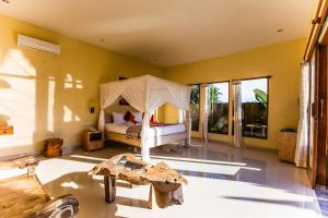 a bedroom with a bed with a canopy at Asri Sari Villa Ubud in Ubud