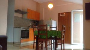a kitchen with a table and chairs in a room at Apartment Frane Grobnik in Dražice