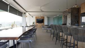 a dining room with tables and chairs and a television at Truntum Boutique Mandalika in Kuta Lombok +272 photos