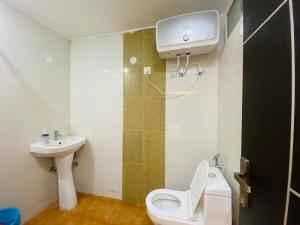 a bathroom with a toilet and a sink at The Starfish Studio in Dehradun +6 photos