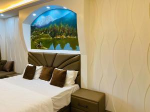 a bedroom with a bed and a painting on the wall at The Starfish Studio in Dehradun