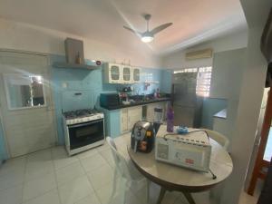 a kitchen with a table with a radio on it at Hostel Suites in Recife