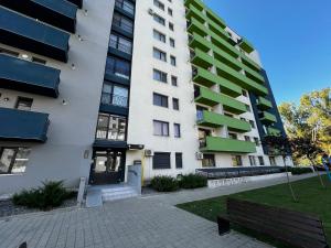 a apartment building with a bench in front of it at SCC2 Apartments in Cluj-Napoca
