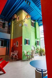 a room with colorful walls and tables and chairs at Hotel Not Hotel Rotterdam in Rotterdam