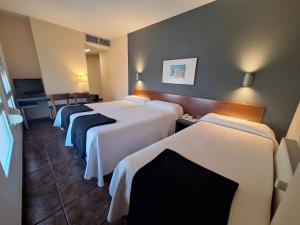 a row of beds in a hotel room at Hotel Yerri in Estella +27 photos