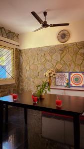 a table in a room with a clock on a wall at Auralis Experience in Jigani