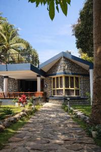 a building with a stone pathway in front of it at Auralis Experience in Jigani