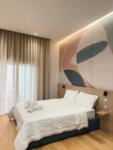 a bedroom with a large bed and a large window at Xhani Boutique Rooms in Durrës