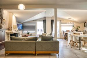 a living room with a couch and a table at Meteora View Penthouse in Kalabaka