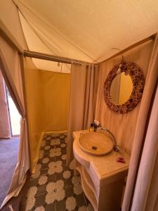 a bathroom with a sink in a tent at Milagro Luxury Camps in Merzouga