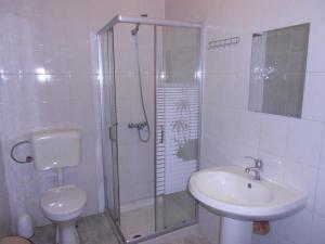 a bathroom with a shower and a toilet and a sink at Roof Top Hostel in Tirana +39 photos