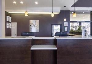 a lobby with a bar with two laptops on it at Quality Inn & Suites Durant in Durant +14 photos