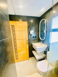 a bathroom with a toilet and a sink and a mirror at nouvelle studio climatisé in Fez +22 photos