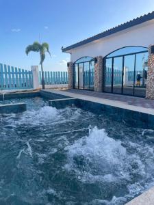 a swimming pool with water in the middle of a house at Casa tequila in Nueva Gorgona