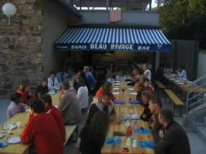 a group of people sitting at tables at a restaurant at ZEcamping 4 étoiles chiens acceptés tennis piscine chauffée in Salles-Curan +89 photos