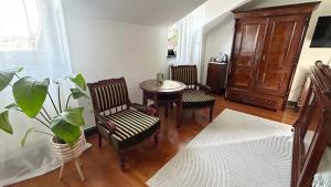 a living room with a table and chairs and a plant at Cyprianówka in Warszowice