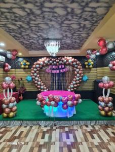 a room with a stage with a bunch of balloons at Hotel Tazzodisha Next in Bhubaneshwar