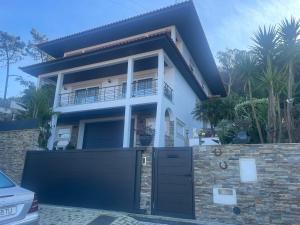 a house with a gate in front of it at Moradia Com Piscina T4 in Esposende