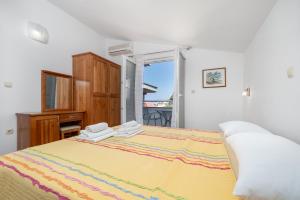 a bedroom with a large bed with two towels on it at Villa Juric 2 in Baška Voda