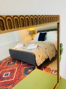 a mirror reflection of a bed in a bedroom at Peartree Cottage in Sandhoe