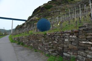 a stone wall with a blue ball on top of it at Hotel Kachelburg in Dieblich
