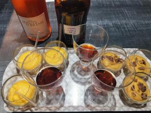 a group of glasses of wine and a bottle of wine at chambres d'hôtes "DINEDORT" in LʼAiguillon-sur-Vie +44 photos