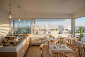 a restaurant with tables and chairs and a large window at B&B Il Palazzotto di Luca Luxury Suites in Lecce