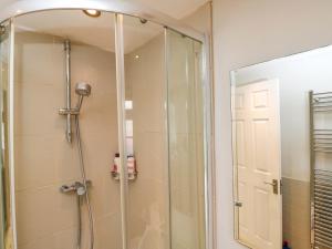 a shower with a glass door in a bathroom at The Barn at Myrtle Cottage in Marlborough +7 photos