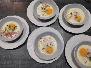 a group of eggs on white plates on a table at chambres d'hôtes "DINEDORT" in LʼAiguillon-sur-Vie