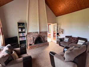 a living room with two couches and a fireplace at The Wild Atlantic Hideaway in Inch
