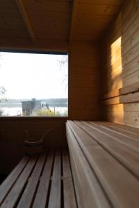 a room with a large window in a wooden cabin at Houseboat Pałuki in Sobiejuchy