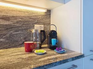 a counter with a coffee maker and cups on it at Apartment Apt- Hermosa by Interhome in Locarno +19 photos