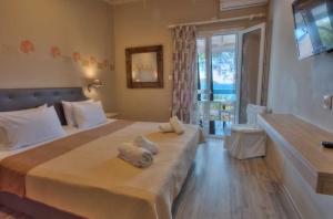 a bedroom with two beds with towels on it at G&J Hotel in Sampong