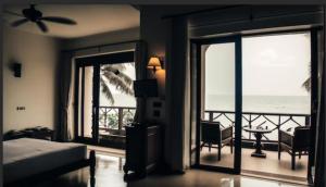 a bedroom with a bed and a view of the ocean at G&J Hotel in Sampong