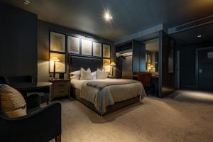 a hotel room with a bed and a desk and a desk at Dakota Leeds in Leeds +60 photos