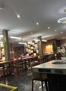 a restaurant with tables and chairs in a room at Studio apartment GRA IKeja in Ikeja