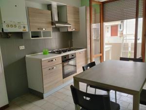 a kitchen with a table and a dining room at Residence Hotel Claudia in Alba Adriatica