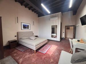 a bedroom with a bed and a table in it at Barberini Guest House Palestrina in Palestrina