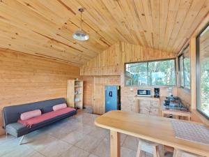 a living room with a couch and a table at Cabaña Ardilla Corralillo in Corralillo
