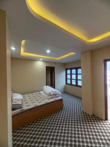 a bedroom with a large bed in a room at Shrestha Hotel And Lodge in Dhāding