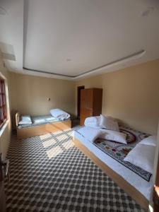 a room with two beds in a room with at Shrestha Hotel And Lodge in Dhāding