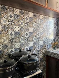 a kitchen with two pots on top of a stove at COZY Two BEDROOM in Bamburi