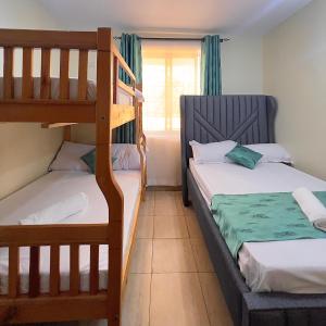 a bedroom with two bunk beds and a window at COZY Two BEDROOM in Bamburi