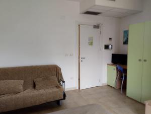 a living room with a couch and a desk at Residence Hotel Claudia in Alba Adriatica