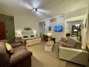 a large living room with a bed and a couch at Hotel Arcadia in Macerata