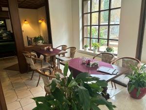 a restaurant with tables and chairs and a window at Benz Café & Pension in Blankenburg