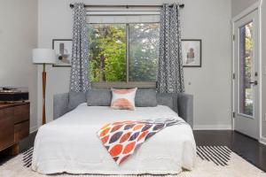 a bedroom with a bed and a window at The Pendleton Boutique Stylish 1 bedroom Condo in Traverse City