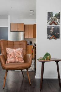 a living room with a chair and a table at The Pendleton Boutique Stylish 1 bedroom Condo in Traverse City