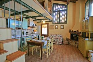 a kitchen and living room with a table and a couch at Casalecchi - Cottage between Siena & Florence in Poggibonsi