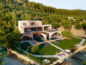 an aerial view of a house on the water at Euphoria Villa, 9 bdrs with private pools, beachfront in Kalogria